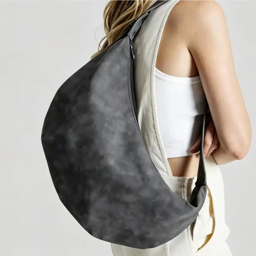 Crescent-shaped shoulder bag with adjustable strap — charcoal worn on shoulder | BTendance