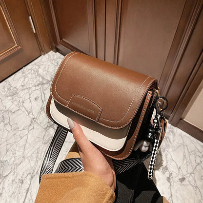 Colour block crossbody bag with patterned strap – Tan and cream bag held in one hand | BTendance