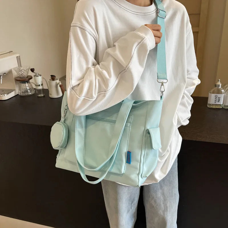 Pocket tote bag with round pouch – Mint bag worn across the body | BTendance