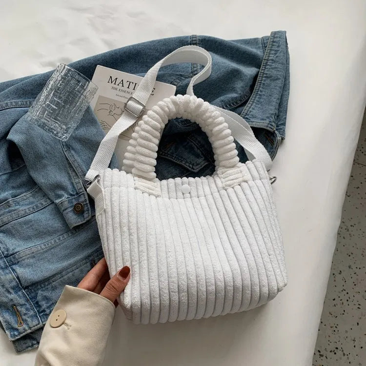 Ribbed plush handbag with rounded handles and long strap — white on denim display | BTendance