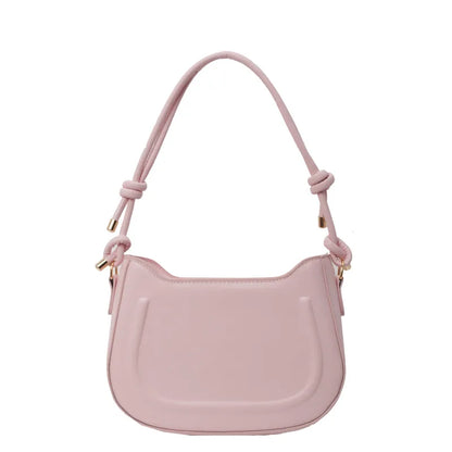Curved shoulder bag with outlined front panel and knotted strap — pink on white background | BTendance