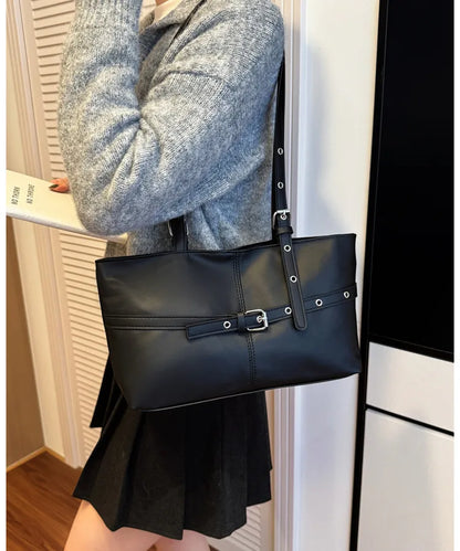 Rectangular shoulder tote with buckle and eyelet detailing — black worn on shoulder | BTendance