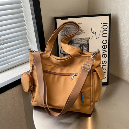 Pocket tote bag with round pouch – Tan bag displayed beside a window | BTendance