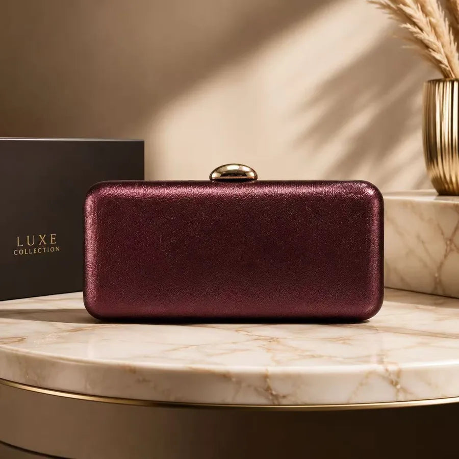 Rectangular evening clutch with oval metal clasp — burgundy on marble display | BTendance