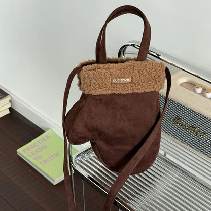 Mitten-shaped crossbody bag with contrasting plush panel — brown with tan cuff held by handle | BTendance