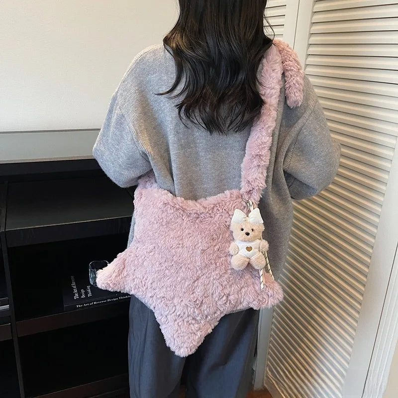 Star-shaped plush shoulder bag with small hanging charm — pink worn on shoulder | BTendance