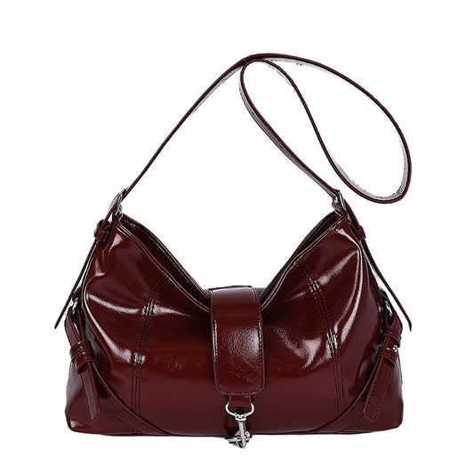 Glossy shoulder bag with central strap and metal clip — burgundy on white background | BTendance