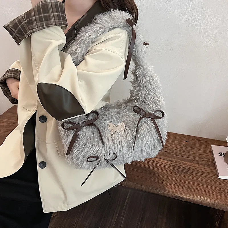 Shaggy plush shoulder bag with ribbon bows — grey worn on shoulder | BTendance
