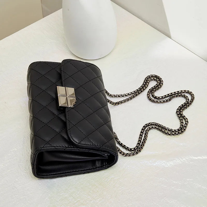 Quilted chain strap crossbody bag – Black bag laid flat showing side profile | BTendance