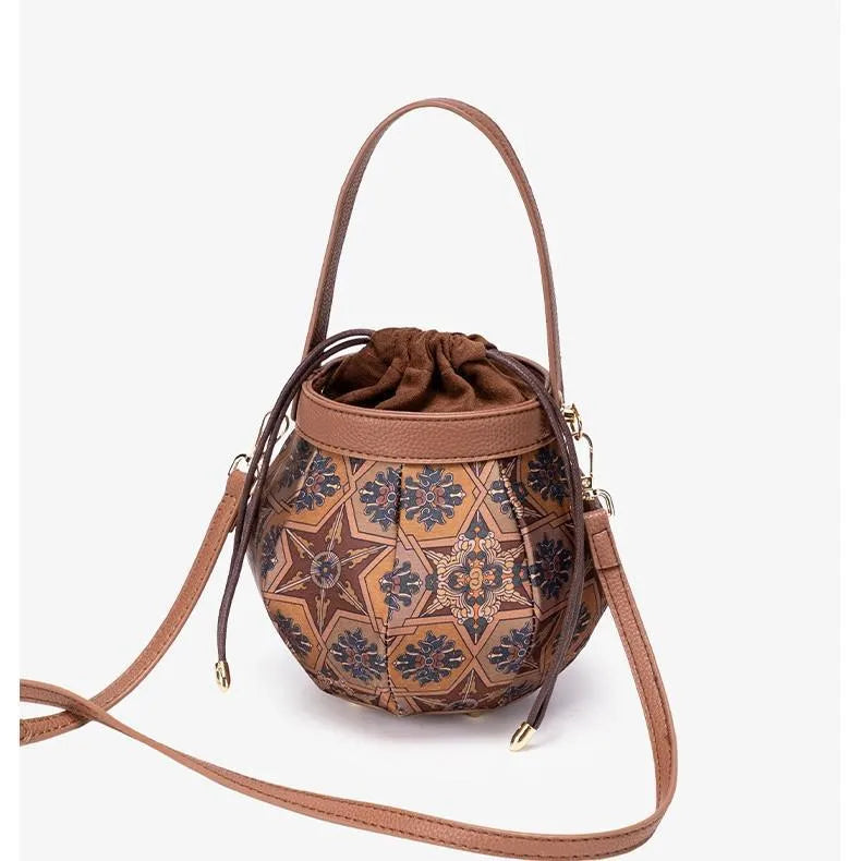 Embroidered drawstring bucket bag – Tan patterned bag with strap extended | BTendance