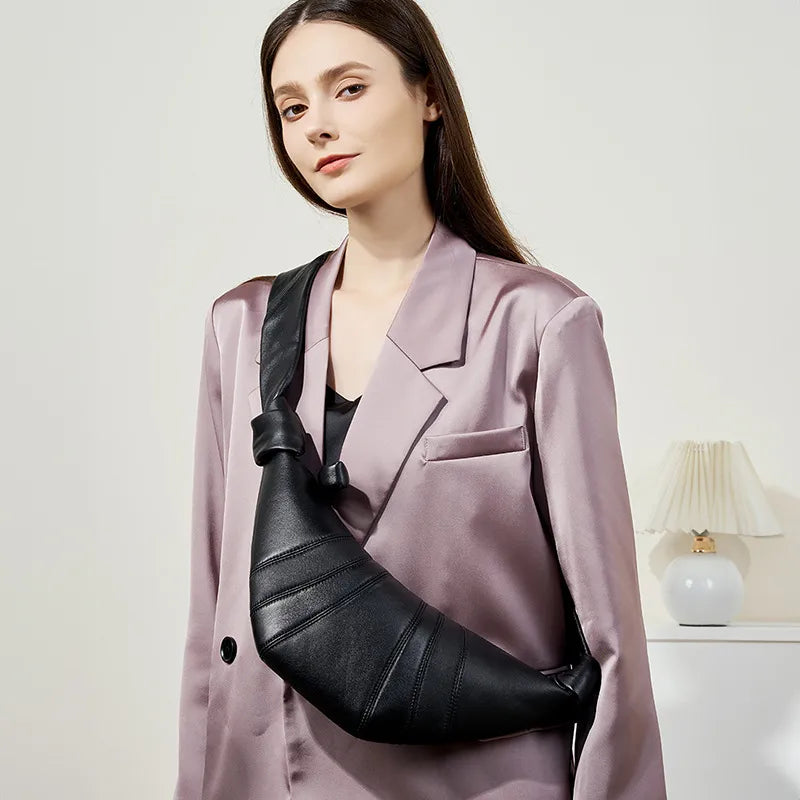 Panelled crescent sling bag – Black bag worn with a mauve blazer | BTendance