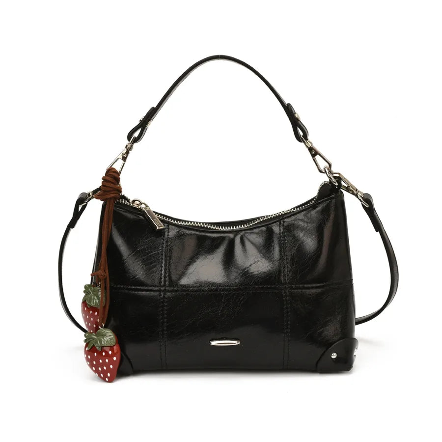Glossy shoulder bag with strawberry charm – Black bag on white background | BTendance