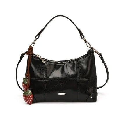 Glossy shoulder bag with strawberry charm – Black bag on white background | BTendance