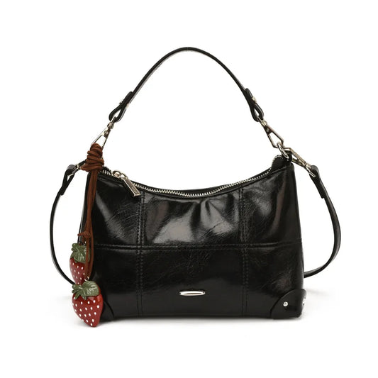 Glossy shoulder bag with strawberry charm – Black bag on white background | BTendance