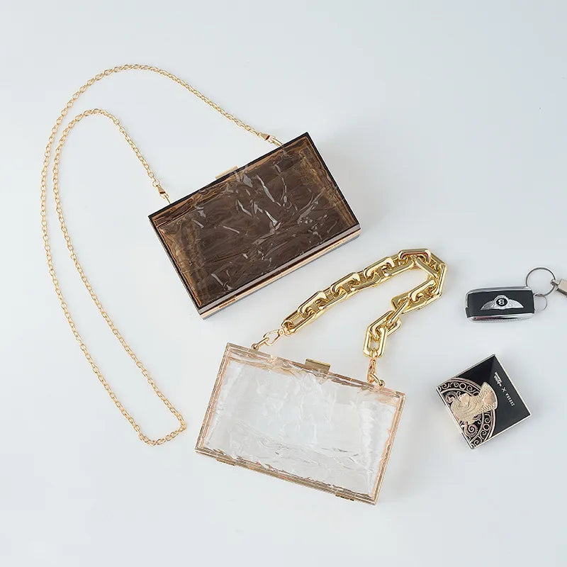 Transparent box bag with gold tone chain – Smoke brown and clear bags laid together | BTendance
