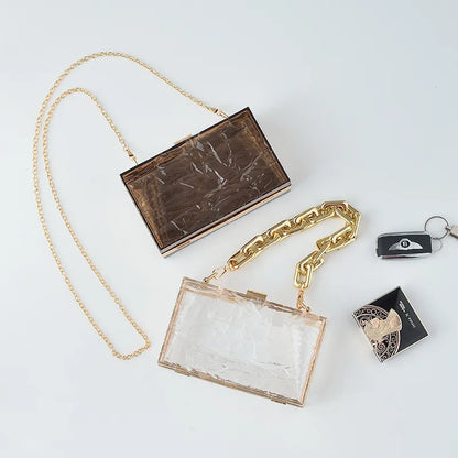 Transparent box bag with gold tone chain – Smoke brown and clear bags laid together | BTendance
