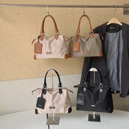 Nylon handbag with contrast handles and shoulder strap — four colors on display | BTendance
