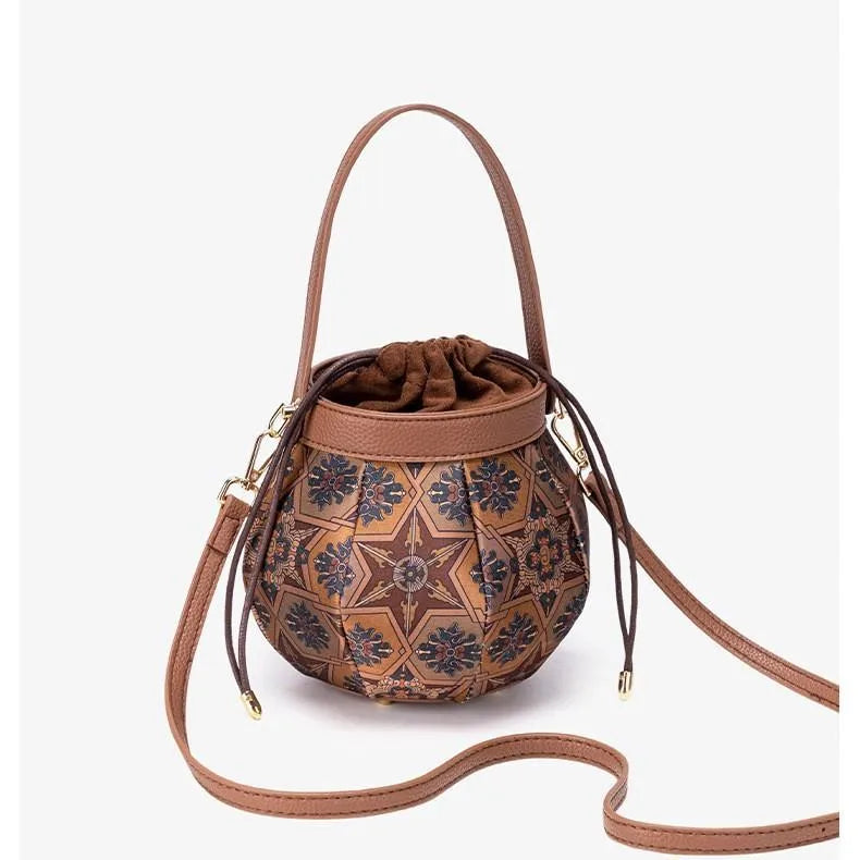 Embroidered drawstring bucket bag – Tan patterned bag with strap curved in front | BTendance