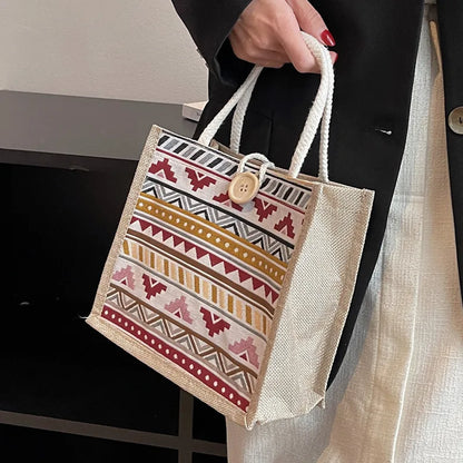 Geometric patterned tote with rope handles – Red accent tote held by its rope handles | BTendance