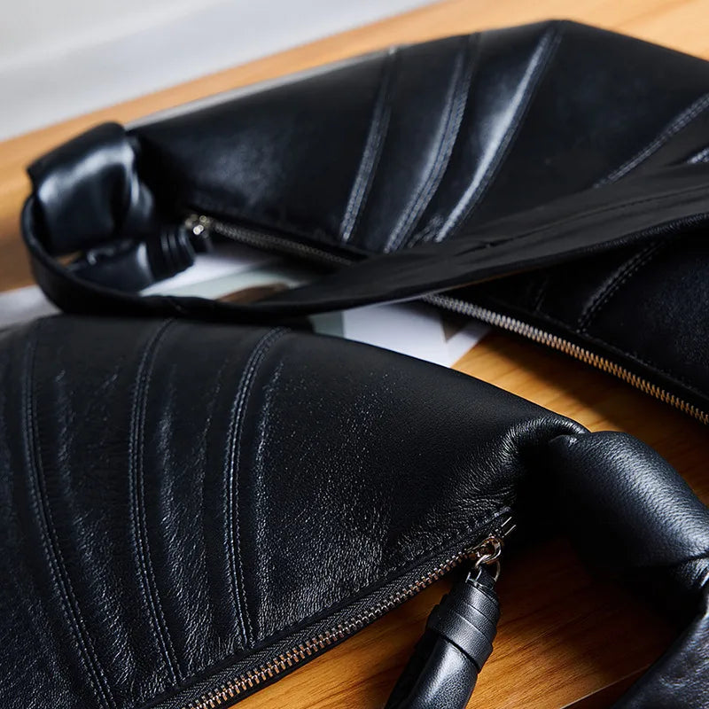 Panelled crescent sling bag – Close view of black panel stitching and zip | BTendance
