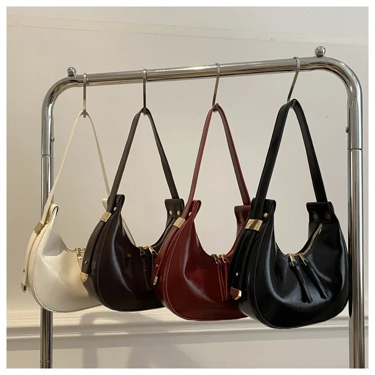 Curved zip shoulder bag – Four colour bags hanging on a rail | BTendance
