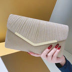 Pleated Envelope Evening Clutch with Metallic Trim – Champagne held for scale | BTendance