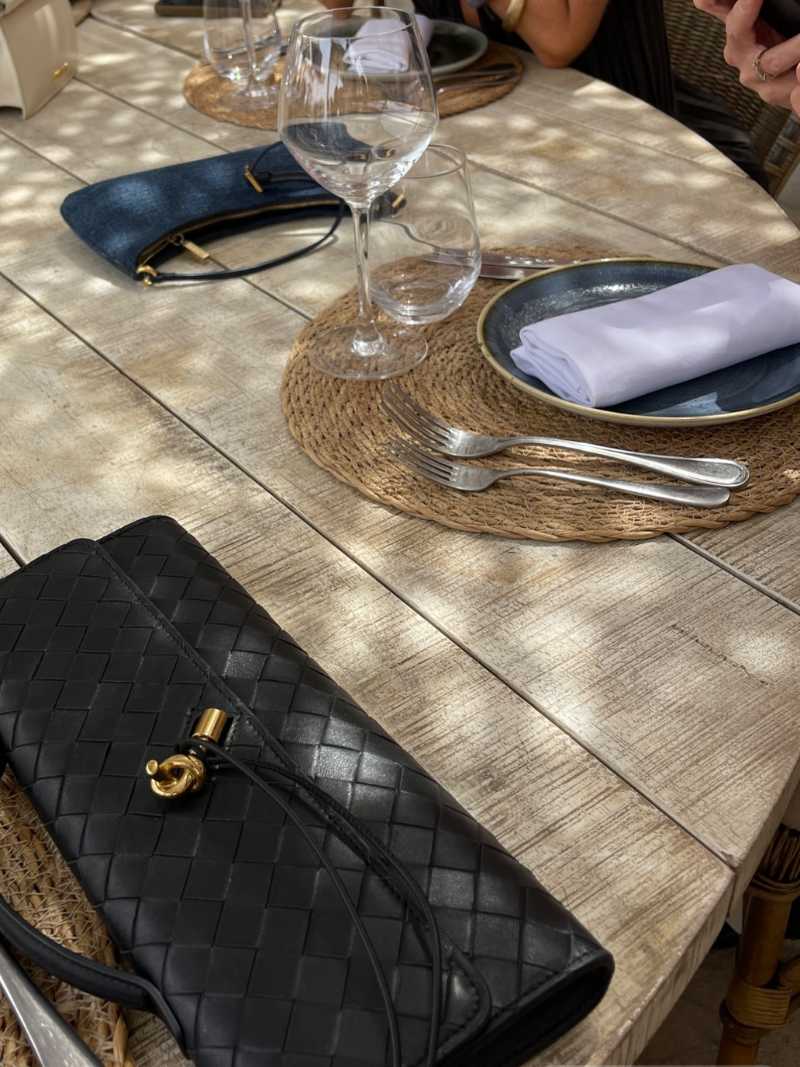 Woven Vegan Leather Baguette Bag – Bianca Gold-Tone Toggle — Black, woven texture on table | BTendance