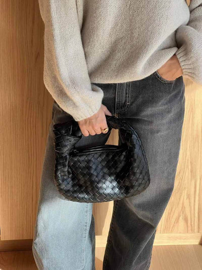 Woven Vegan Leather Mini Handbag – Knotted Handle — Black, hand carrying for scale | BTendance